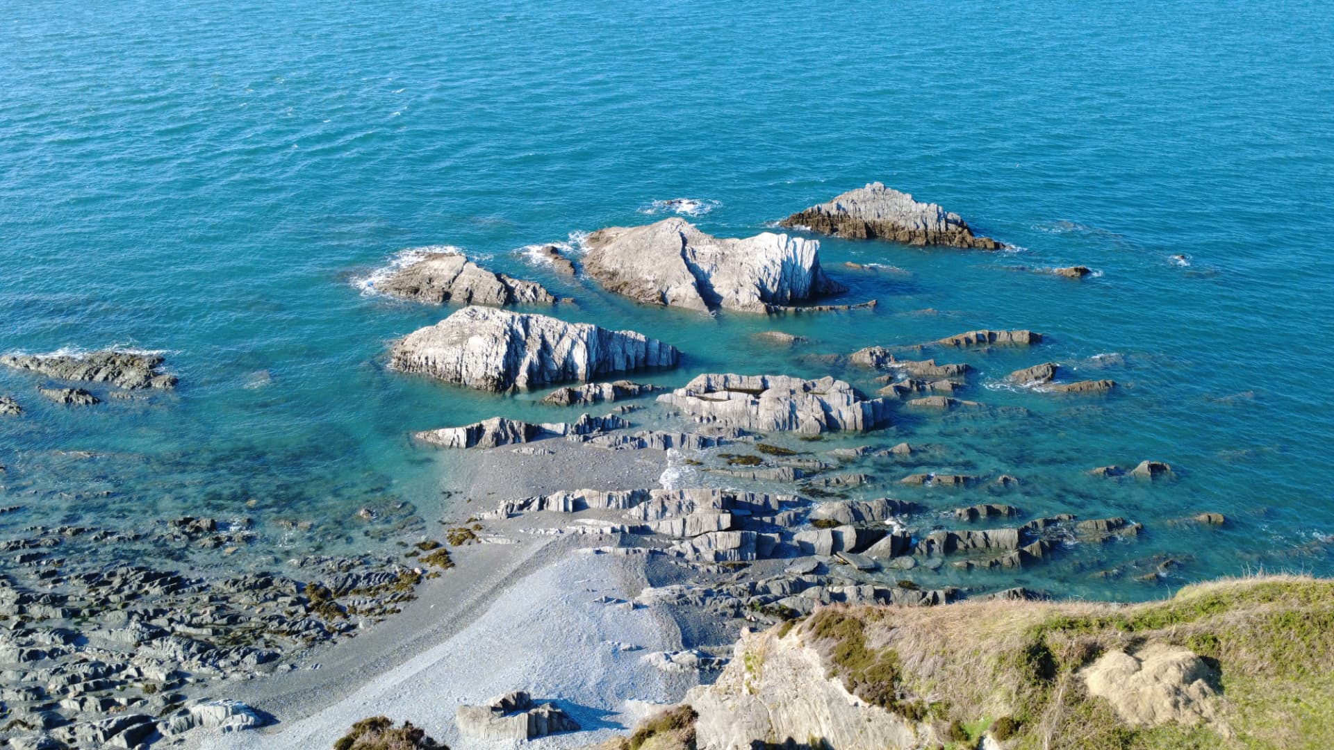 Clear turquoise water and pale rock formations on the Devon coastline